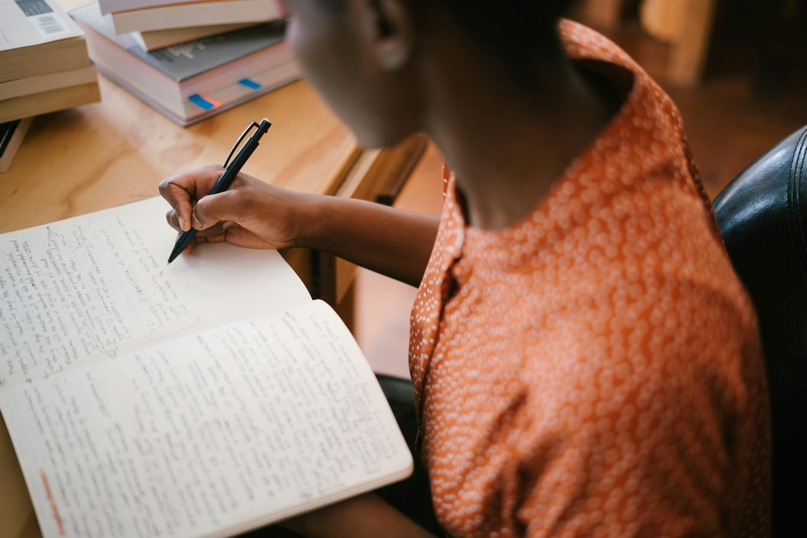 photo of woman writing on notebook